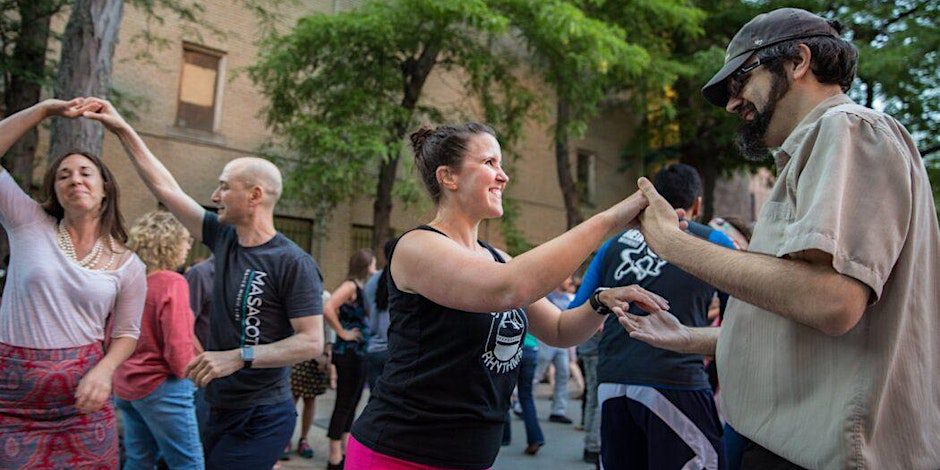 People smiling while salsa dancing outside